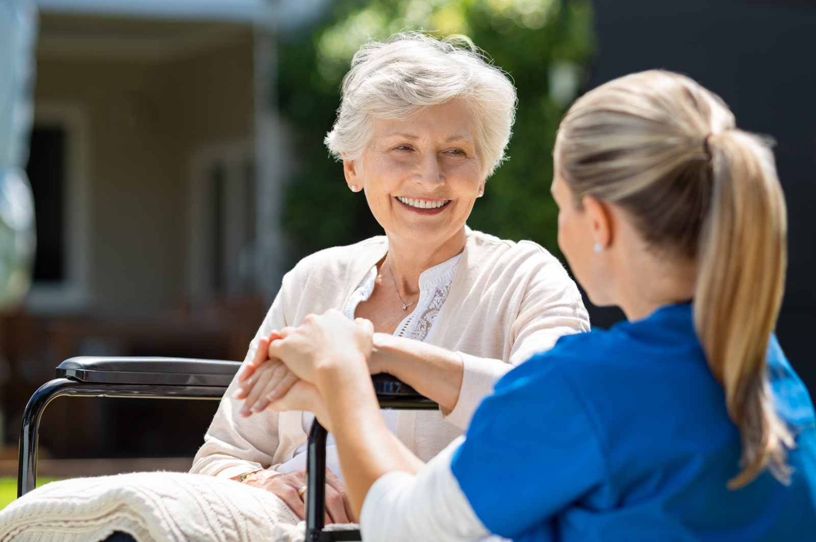 memory care staff interacting with senior living resident